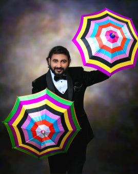 Magician vasanth performing magic with two umbrellas